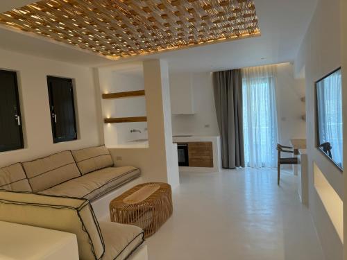 a living room with a couch and a table at Yialos Ios Hotel in Ios Chora