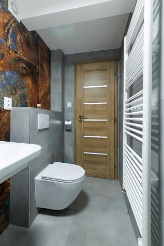 a bathroom with a toilet and a sink at APARTMÁNY Sninský dvor in Snina