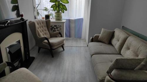 a living room with a couch and a chair at Neversea Remus Opreanu in Constanţa