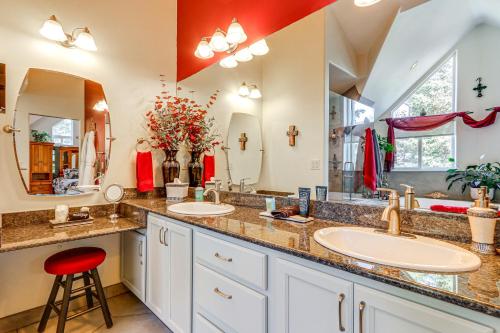 a bathroom with two sinks and two mirrors at Palmer Getaway with Mountain Views and Fire Pit! in Palmer