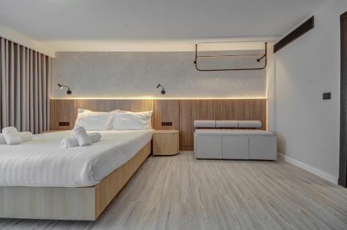 a bedroom with a large white bed and a desk at Noru Hotel Malta - Adults Only Hotel in St Julian's
