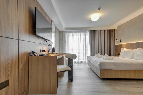 a hotel room with a bed and a desk at Noru Hotel Malta - Adults Only Hotel in St Julian's