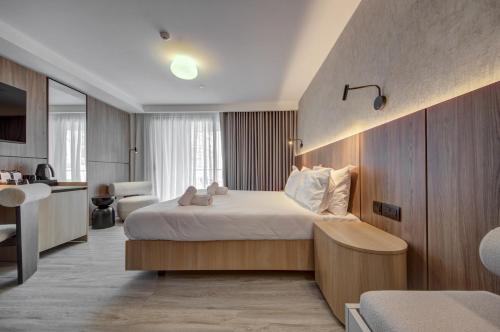 a hotel room with a bed and a desk at Noru Hotel Malta - Adults Only Hotel in St Julian's