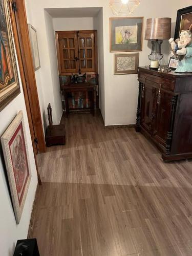 a living room with a hard wood floor and a hallway at Casa A Boga RIBEIRA SACRA in Abeleda