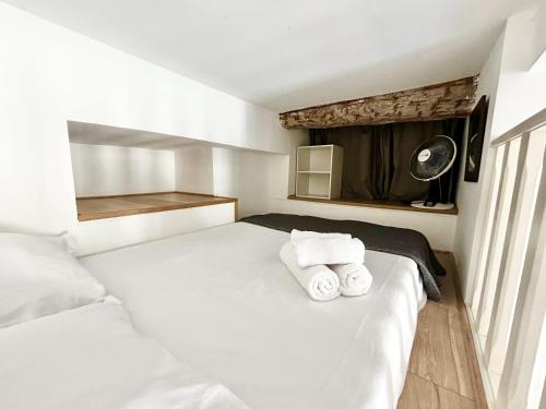 - une chambre avec 2 serviettes blanches sur un lit dans l'établissement ApartHotel Riviera - Villa Massena - Grimaldi Promenade des Anglais, à Nice