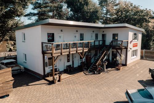 a small white house with a staircase in front of it at Down Town Motel in Berlin
