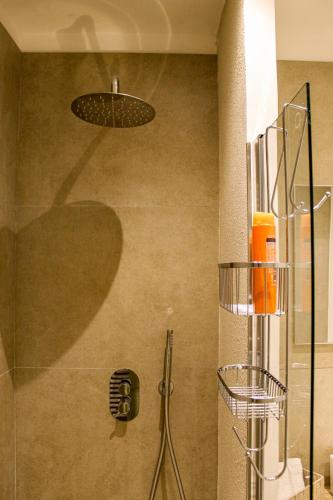eine Dusche mit Glastür und Duschkopf in der Unterkunft Holiday Home MATT ROS in Noto