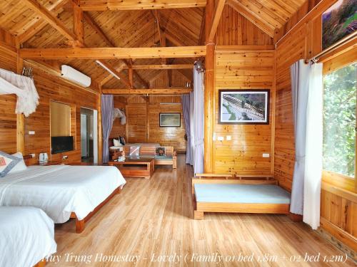a bedroom with a bed in a wooden room at Huy Trung Homestay in Bắc Hà