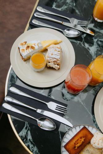 a plate of food on a table with utensils at Drawing House in Paris