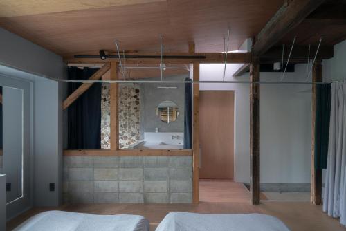 a bedroom with a sink and a mirror at SEW STAY Soft Seam KYOTO MAIZURU in Maizuru