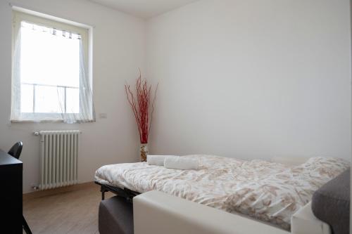 a white bedroom with a bed and a window at Charme House Trulli, Bari, Polignano, Monopoli 5 star in Turi