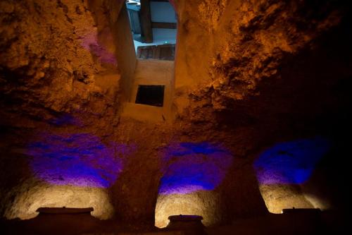 an alley way with blue and purple lights at Apartamentos Turísticos La Bodegueta in Utiel