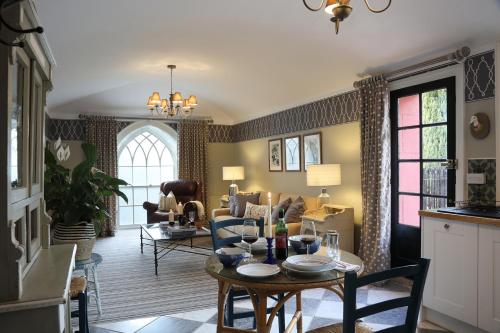 a living room with a table with wine glasses on it at Cathedral View - Romantic Wye Valley Country House 1 Bed Apartment - Dog Friendly in Coleford