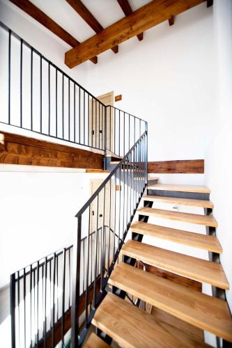 a staircase in a house with wooden floors and beams at Apartamentos Turísticos La Bodegueta in Utiel