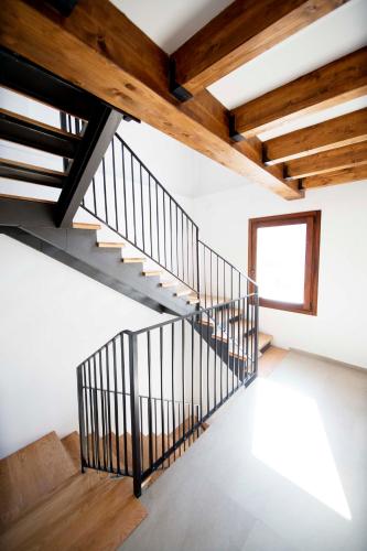 a staircase in a house with wooden beams at Apartamentos Turísticos La Bodegueta in Utiel