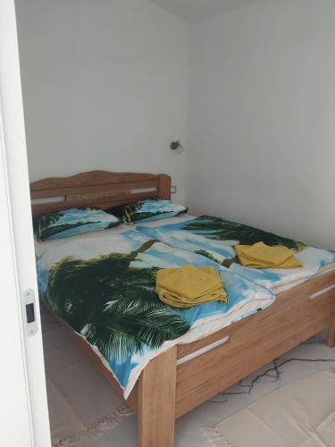 a bed with two yellow shirts on top of it at Villa Sunce Funtana in Funtana