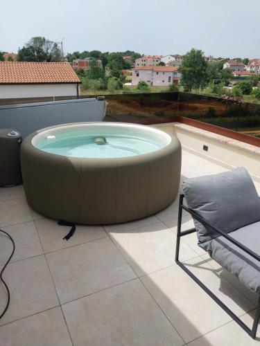 a hot tub on the roof of a house at Villa Sunce Funtana in Funtana
