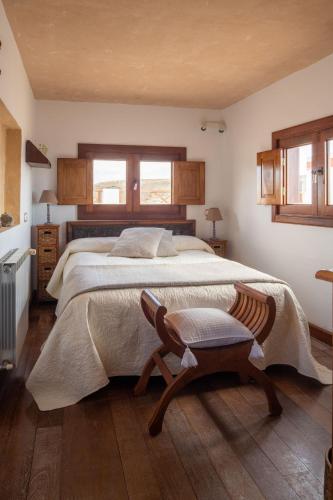 a bedroom with a large bed and a chair at Casa Amanecer in Haría