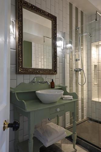 a bathroom with a green sink and a mirror at Cathedral View - Romantic Wye Valley Country House 1 Bed Apartment - Dog Friendly in Coleford