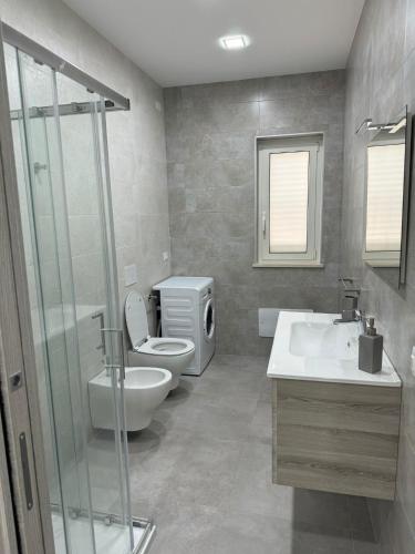 a bathroom with a toilet and a sink and a shower at Holidays Apartments Tropea in Tropea