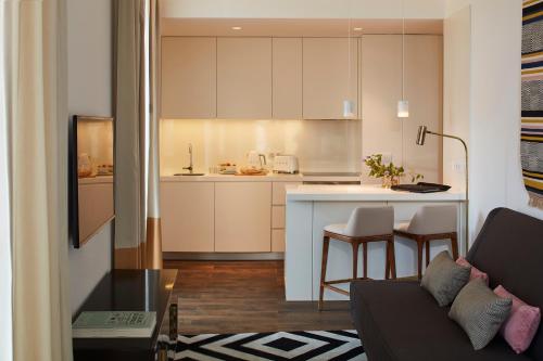 a living room with a couch and a kitchen at The Lumiares Hotel & Spa - Small Luxury Hotels Of The World in Lisbon