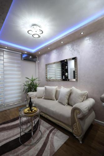 a living room with a couch and a blue ceiling at Imperial Lux Apartment in Kragujevac