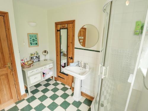 a bathroom with a sink and a shower at Daisy Cottage in Lincoln