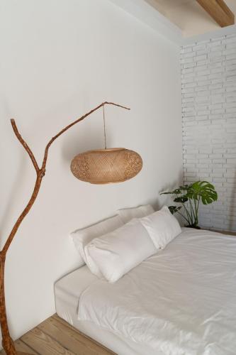 a room with a bed with a lamp and a plant at 19bnb獨立小屋 in Xiaoliuqiu