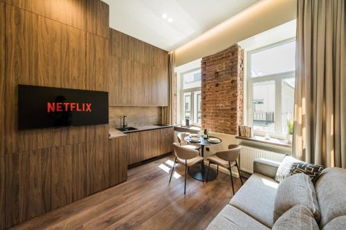 a living room with a couch and a table at Central Park Apartments - The Luxury Collection in Kaunas