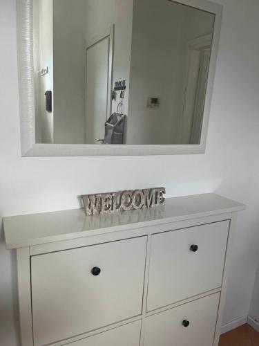 a white dresser with a mirror on top of it at Morbegno holiday house in Morbegno