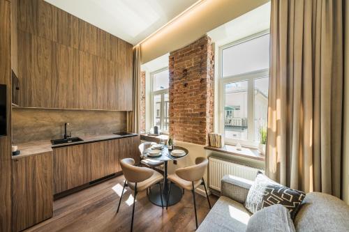 a living room with a couch and a table at Central Park Apartments - The Luxury Collection in Kaunas