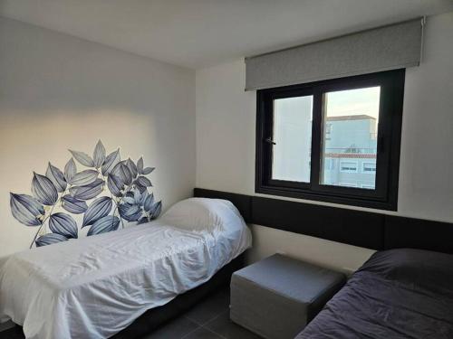 En eller flere senge i et værelse på Departamento Punta del Este