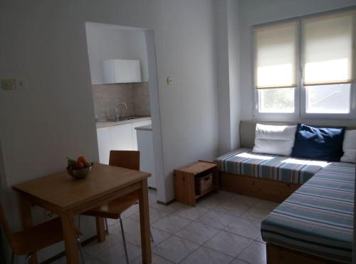 a small room with a table and a kitchen with a couch at Apartman Nela Banjole in Banjole