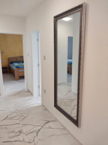 a mirror on a wall next to a bedroom at Villa Sunce Funtana in Funtana