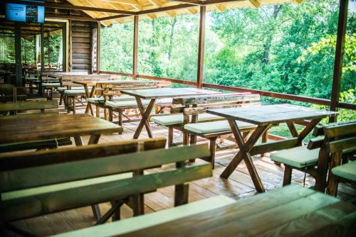 an empty restaurant with wooden tables and benches at Wooden Village Resort in Ponari