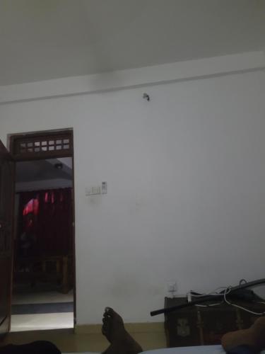 a person sitting on the floor in a room at Araliya in Wattala