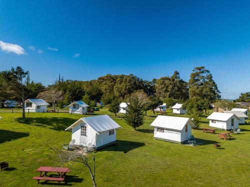 a group of buildings in a field with a picnic table at Costanoa in Pescadero