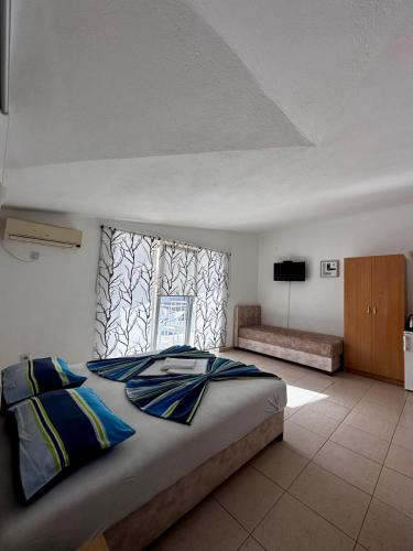 a bedroom with a large bed and a window at Apartmani ARIANA in Dobra Voda
