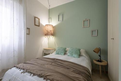 a bedroom with a bed with two pillows on it at Trilocale vista spiaggiamare in Diano Marina