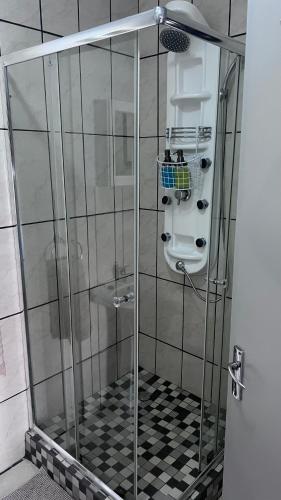 a shower with a glass door in a bathroom at Lumis Rest in Tzaneen