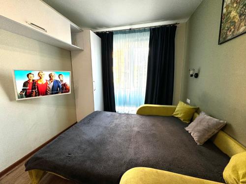 a bedroom with a large bed with a tv on the wall at New apartments, center, Smart TV in Kharkiv