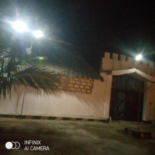 a building with two lights on top of it at night at Rafiki Backpackers-hostel in Nungwi