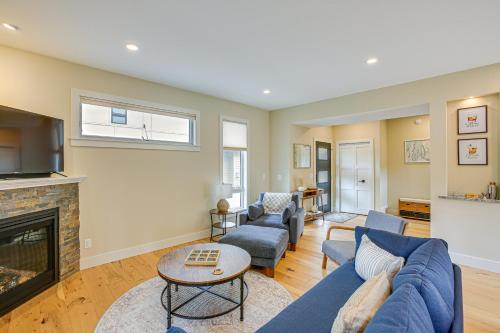 a living room with a blue couch and a fireplace at Traverse City Townhome Walk to Boardman Lake! in Traverse City