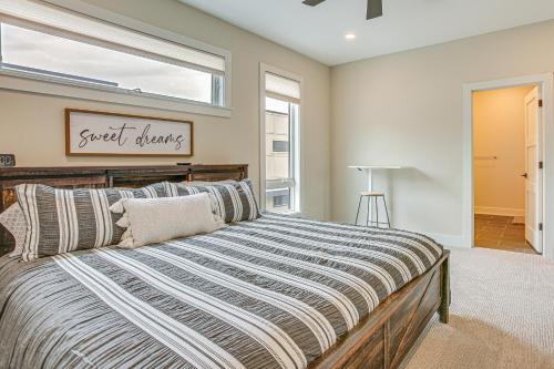 a bedroom with a large bed with a window at Traverse City Townhome Walk to Boardman Lake! in Traverse City