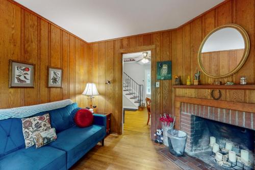 a living room with a blue couch and a fireplace at Fieldcrest in Brevard