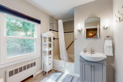 a bathroom with a sink and a shower and a window at Fieldcrest in Brevard
