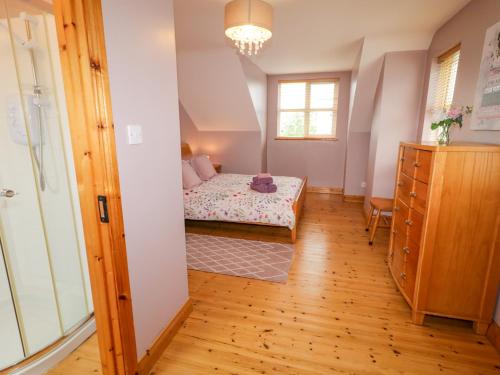 a small bedroom with a bed and a window at 46 Dunalinn in Culdaff