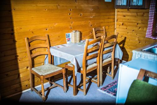 a dining room table and chairs in a room at Wooden Village Resort in Ponari