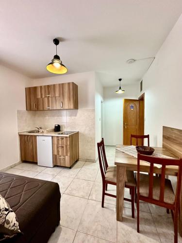 a living room with a dining room table and a kitchen at Villa IL Mare in Budva