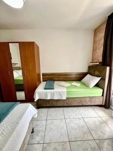 a bedroom with two beds and a mirror at Villa IL Mare in Budva